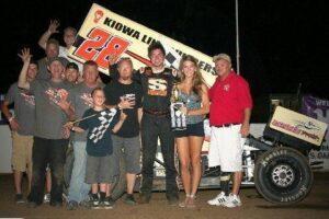 Sedalia Missouri's Jonathan Cornell is joined by friends and crew mates as he accepts his 360 Winged Sprint feature trophy from Double-X Speedway trophy girl Kassi Meisenheimer and director of competition Roy Wood.