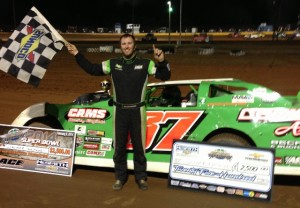Walker Arthur of Forest, VA raises the checkered flag in victory after winning the 50-lap NeSmith Chevrolet Dirt Late Model Series main event on Saturday night driving the Cecil B. Arthur Beef Farms Special in the Super Bowl of Racing Presented By Rock Auto.com at Golden Isles Speedway in Brunswick, GA  (NeSmith Racing Photo)