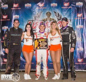 Kyle Larson advanced position 33 times to finally land in Victory Lane in Tuesday's Warren Cat Chili Bowl Opener. Larson was joined on the podium by Brad Loyet and Spencer Bayston. (Chili Bowl / Pat Grant)