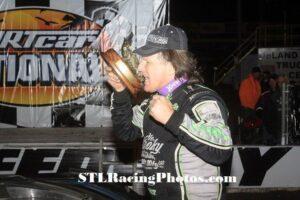 Scott Bloomquist bites the tail of the Alligator on the trophy after winning $10,000 at Volusia Speedway Park's DIRTcar Nationals!