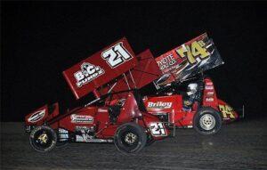 Tyler Thomas (21) and John Carney II (74b) battle for the lead in the closing laps of Friday's 305 Sprint Car Shootout preliminary feature at Southern New Mexico Speedway.