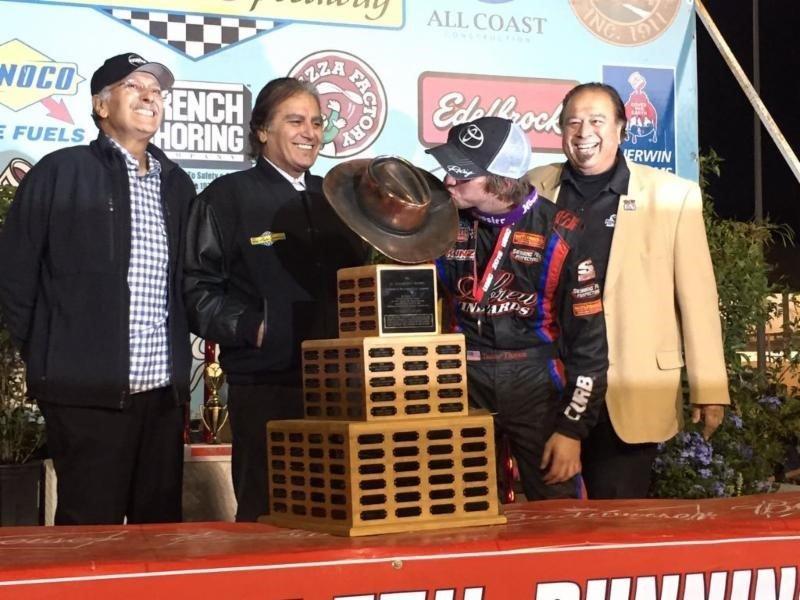 Tanner Thorson of Minden, Nev. kisses the "Aggie" trophy after winning the 2015 "Turkey Night Grand Prix" at Perris (Calif.) Auto Speedway as Cary, Chris, and J.C. Agajanian, Jr. look on.