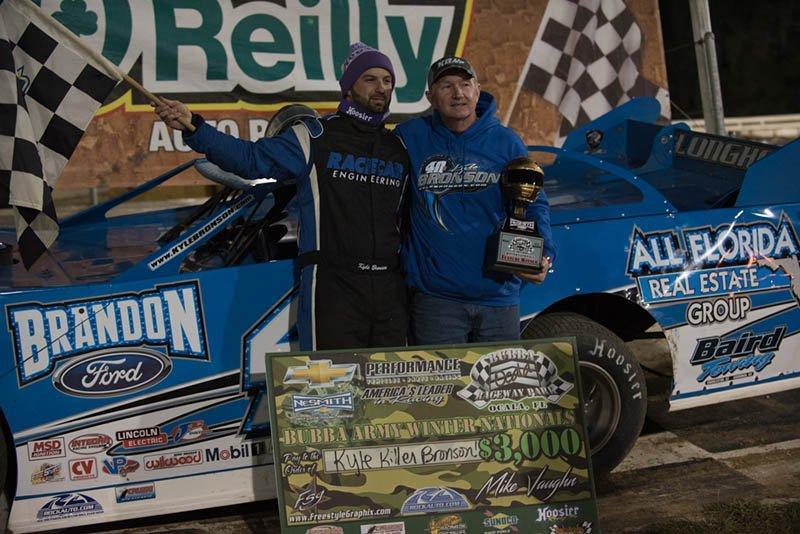 Kyle Bronson of Brandon, FL celebrates a hard-earned win on Saturday with car owner Wayne Hammond after Bronson drove the Brandon Ford Special to victory in Round 3 of the RockAuto.com Winter Shootout for the NeSmith Chevrolet Dirt Late Model Series at Bubba Raceway Park in Ocala, FL. (NeSmith Media Photo by Bruce Carroll)