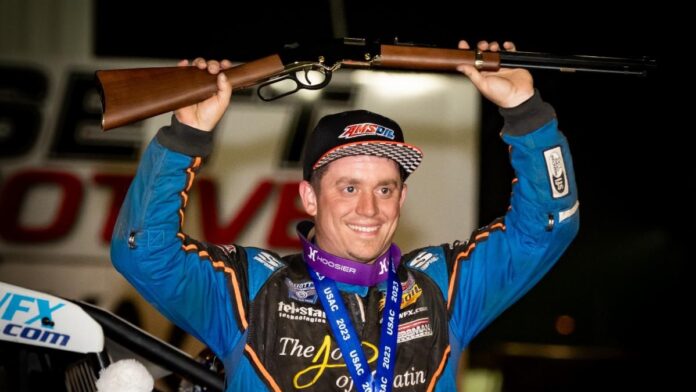Brady Bacon (Broken Arrow, Okla.) holds the traditional Tony Hulman Classic winner's rifle in the air following his USAC AMSOIL Sprint Car National Championship feature victory on Tuesday night at the Terre Haute (Ind.) Action Track. (Indy Racing Images Photo)